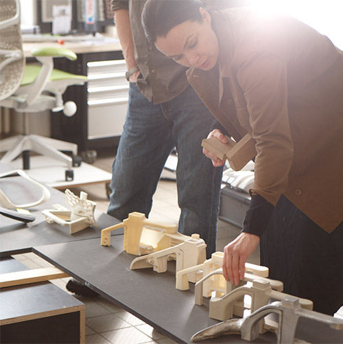 Member of Herman Miller product development team handling office chair prototype components