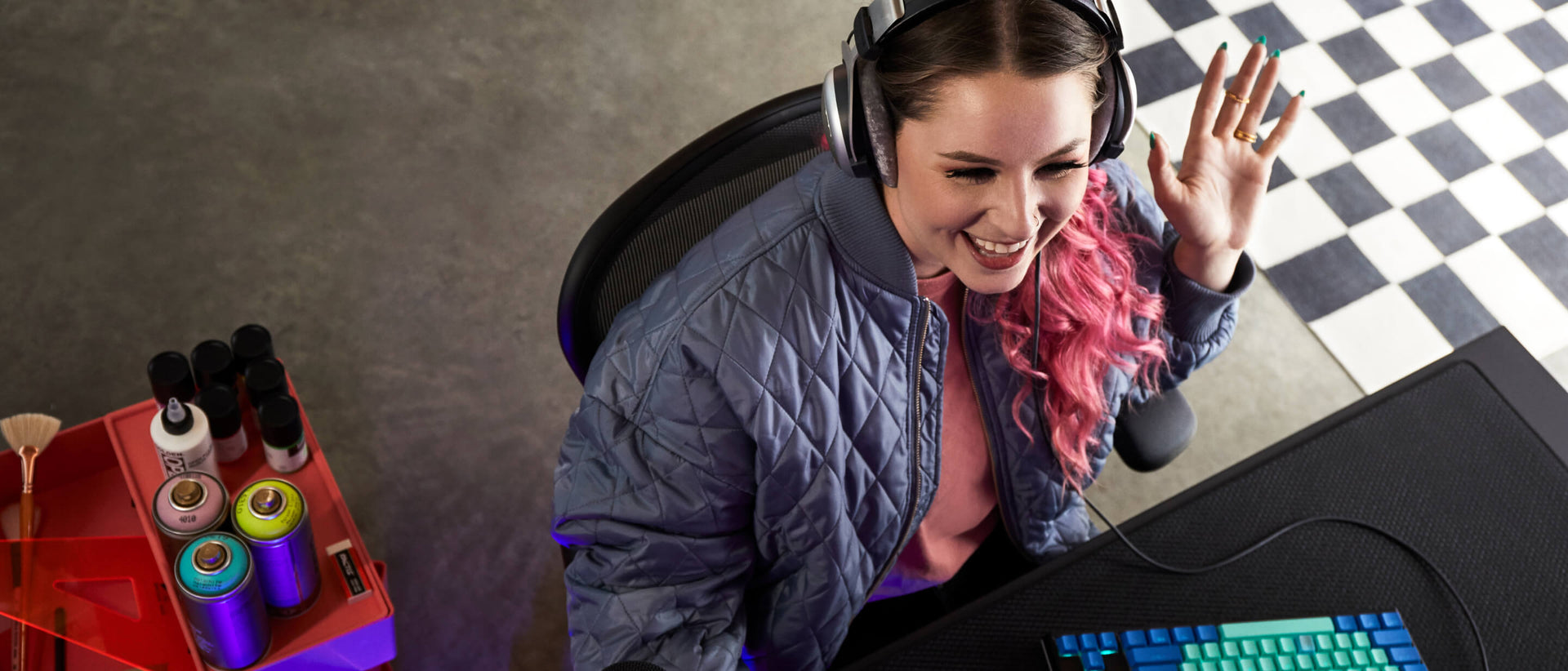 Top down view of Electra smiling whilst playing computer games