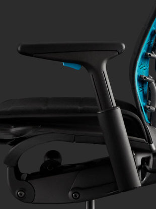 Side view of a blue and black Embody gaming chair by Herman Miller.