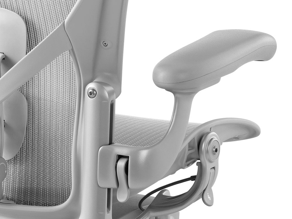 Close of of Aeron mineral from back showing the arm and seat adjustment levers