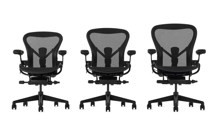 A line-up of Aeron office chairs by Herman Miller, showing the three sizes available.