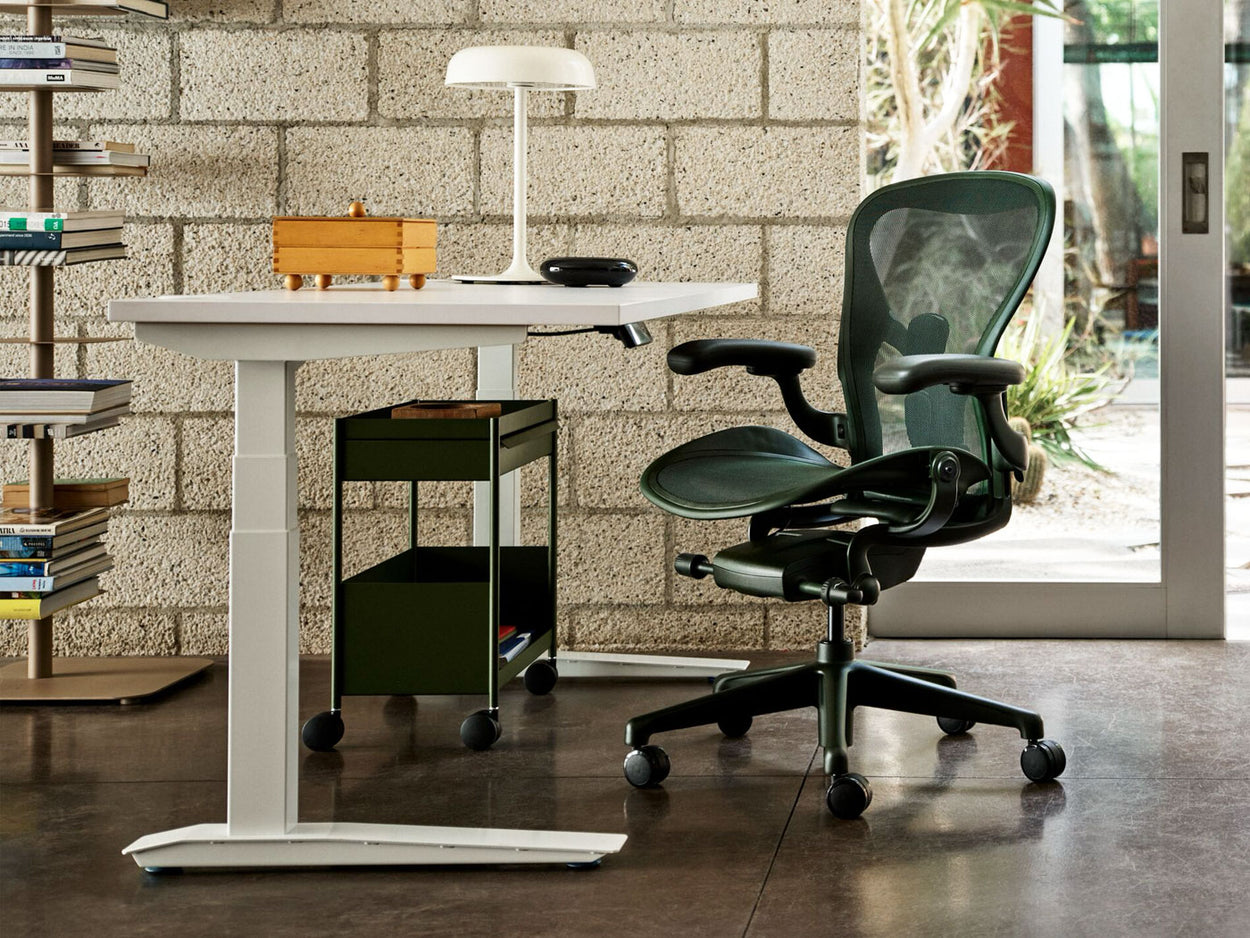 A Herman Miller Aeron office chair as part of a bright home-office setup.