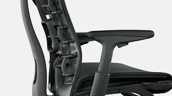 Close-up of a white and blue Embody office chair by Herman Miller, showing the rear of the backrest.