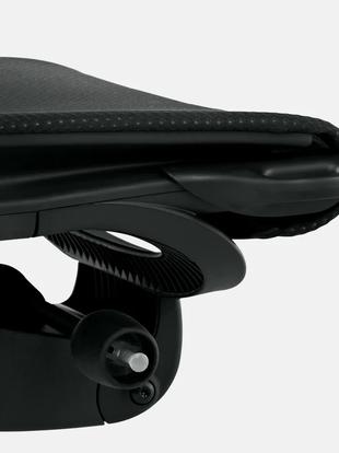 Close-up of a white and grey Embody office chair by Herman Miller, showing the tilt adjustment.