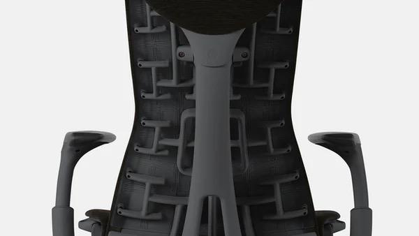 Close-up of a black and grey Embody office chair by Herman Miller, showing the rear of the backrest.