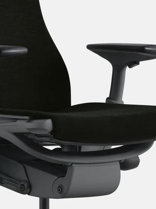 Close-up of a white and blue Embody office chair by Herman Miller, showing the contoured seat.