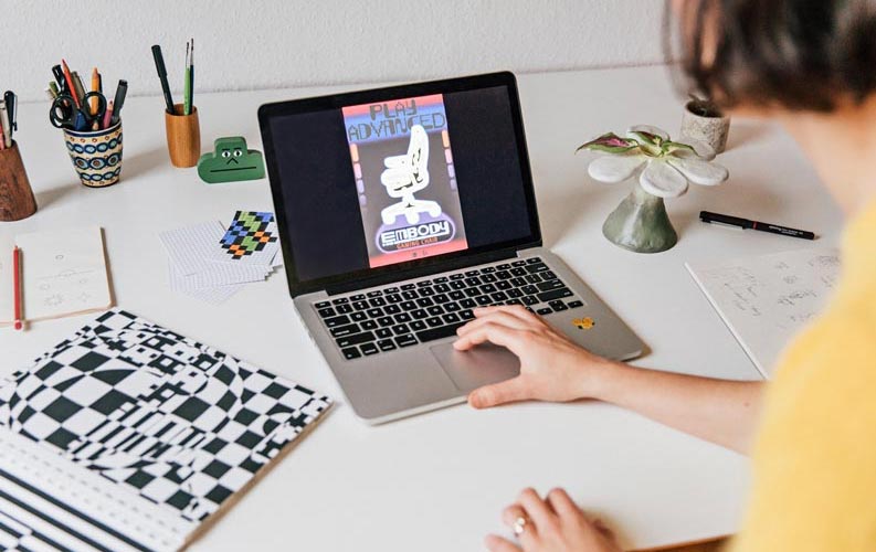 Designer Molly Rose Dyson working on Herman Miller Embody poster on a laptop