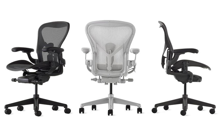 A line-up of Aeron office chairs by Herman Miller, showing the three colours available - Graphite, Onyx and Mineral.
