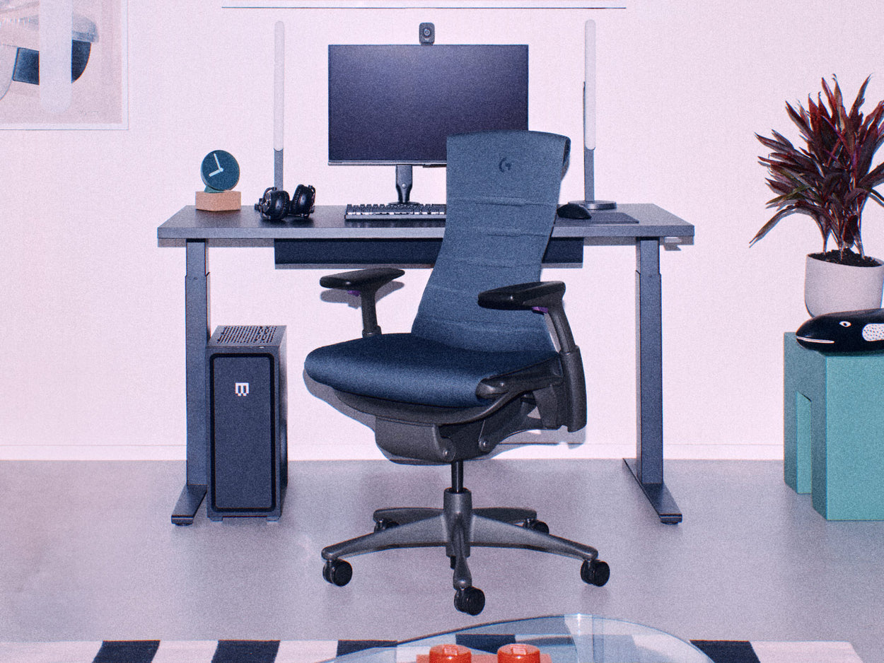 Herman Miller black Embody gaming chair with black Nevi sit-stand gaming desk with gaming set up inlcuding dual monitors