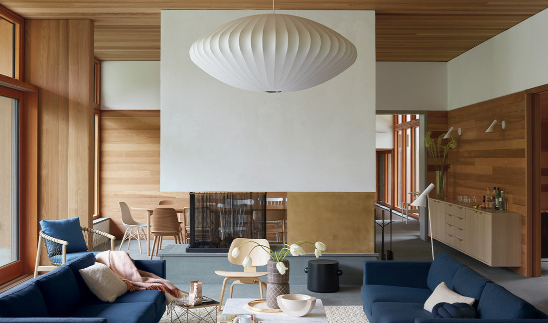 A bright mid-century modern living room with a large George Nelson Bubble Pendant light shade.