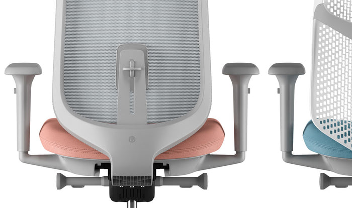 Rear view of a grey and pink Verus office chair by Herman Miller, showing the Suspension back.