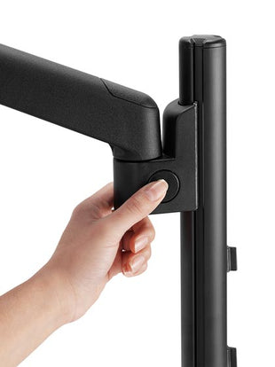 Close-up of a black Lima monitor arm by CBS, showing the push button technology.