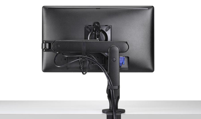 Rear view of a black Ollin monitor arm by CBS, showing the integrated cable management.