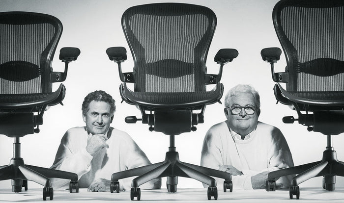 Picture of Don Chadwick and Bill Stumpf through a line up of Aeron office chairs which they designed