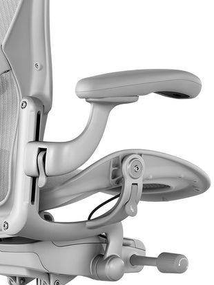 Close-up of arm adjustment controls of an Aeron office chair by Herman Miller.