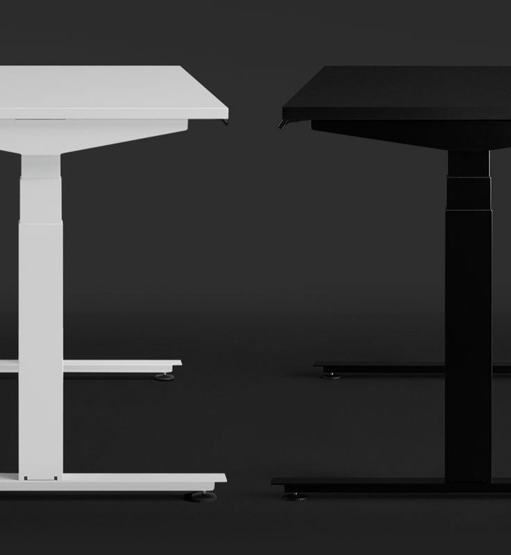 A white and black Nevi gaming desk by Herman Miller is shown side by side, highlighting the different colour and surface options.