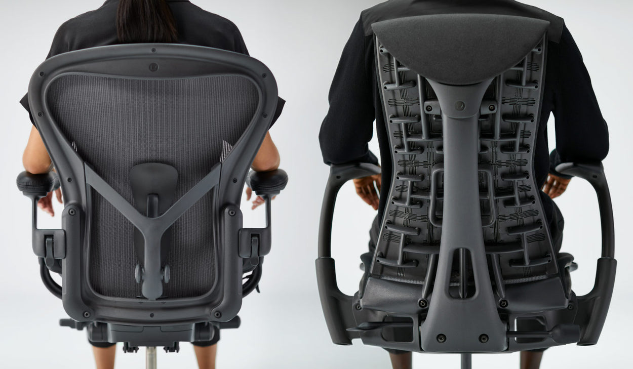 Close rear view image of people sat upright in Aeron office chair in graphite and Embody office chair in black