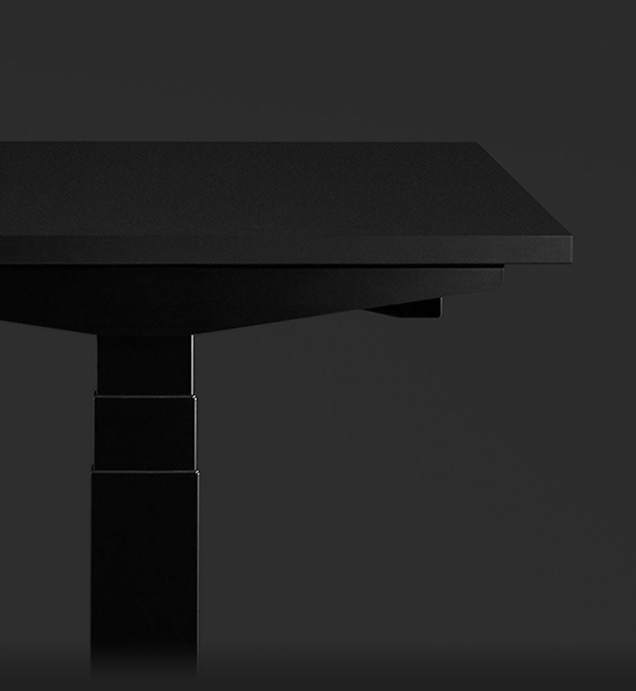 Close-up side view of a black Nevi gaming desk by Herman Miller, showcasing the cable management feature.