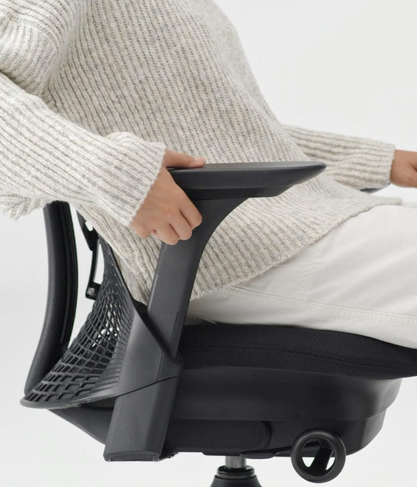 Side view close up of arm adjustment mechanism being used on Sayl office chair in graphite