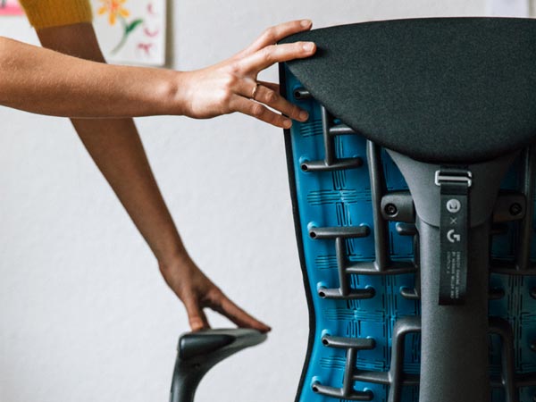 Close up rear view of Embody gaming chair showing the cyan blue back showing the structure of the seat back