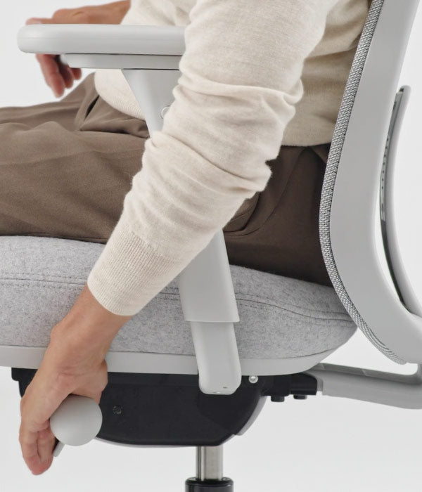 Close up side view of back position adjustment mechanism being used on Lino office chair in mineral