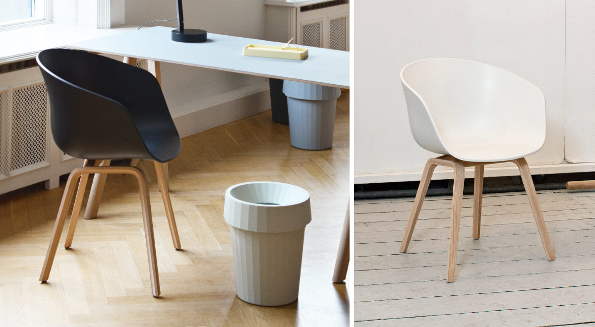 A collage of two images showing two AAC22 chairs, one black and one white. Set in an indoor environment with wooden floors and white walls.