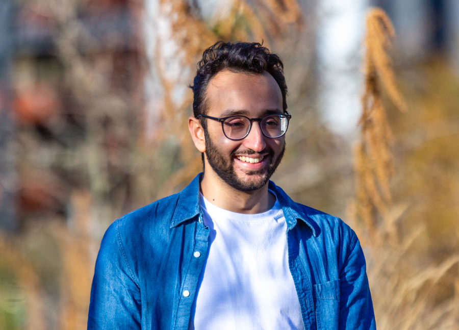 Cheerful photo of Ali Abdaal outside