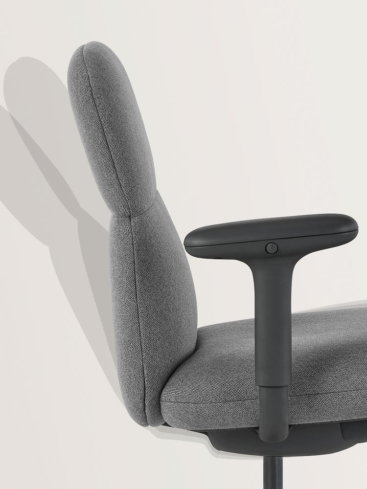 Side view of a grey Asari office chair by Herman Miller, showcasing the self-adjusting tilt mechanism.
