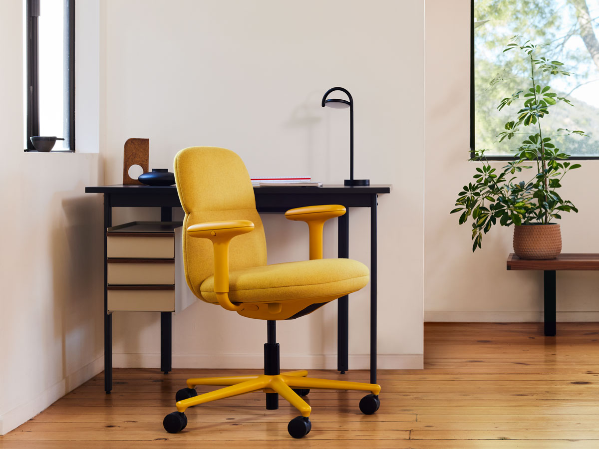 A yellow Asari Chair by Herman Miller, upholstered in Clarion Luce fabric by Maharam - with a Mode Desk and Marselis Lamp