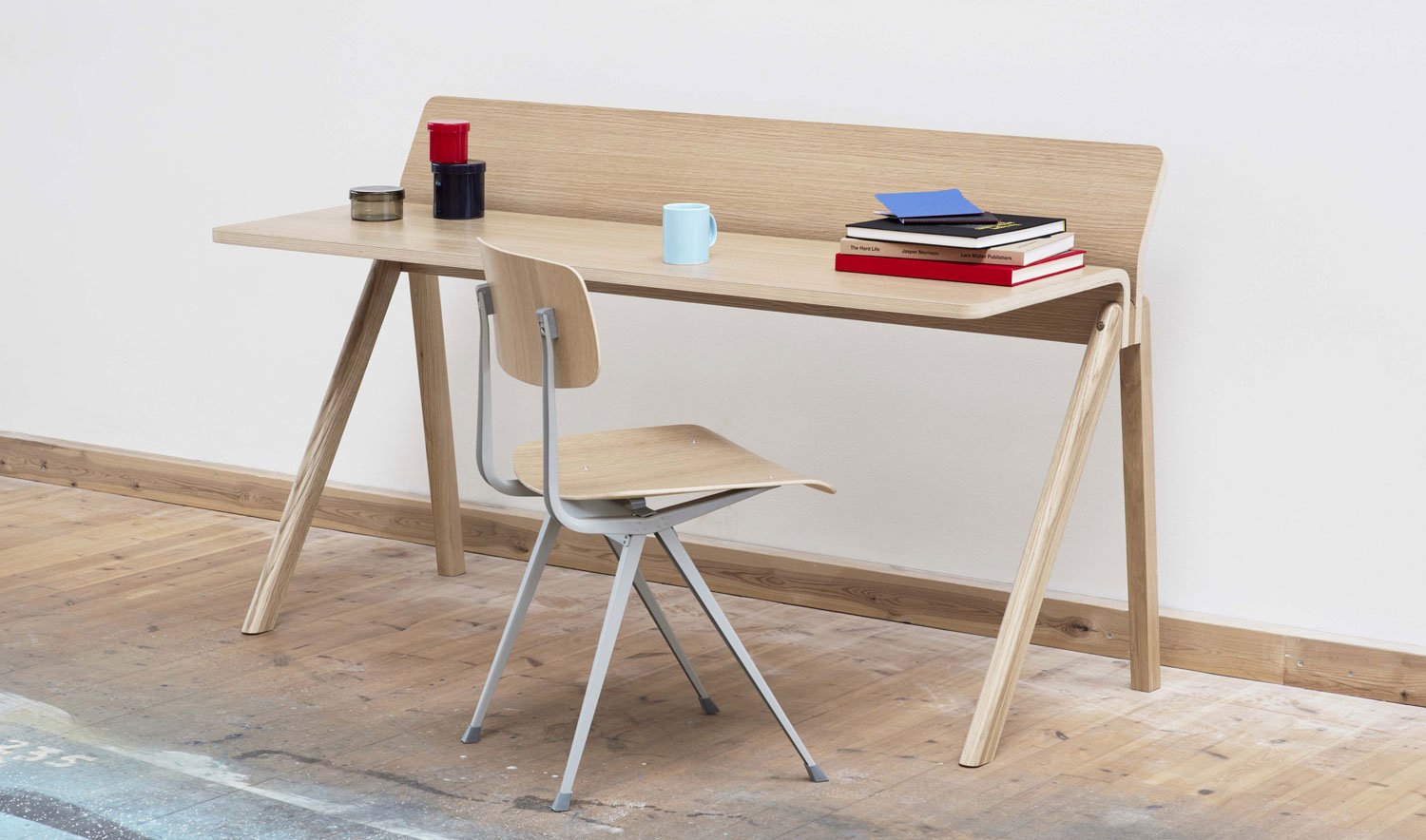 An oak Copenhague 190 desk by HAY, set in an indoor space with wooden floors and white walls.