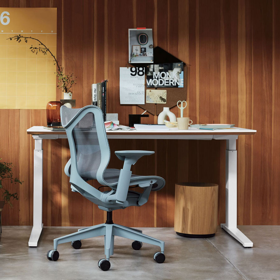 Home office setting featuring low back Cosm office chair in glacier grey in front of Nevi sit-stand desk with white legs and top