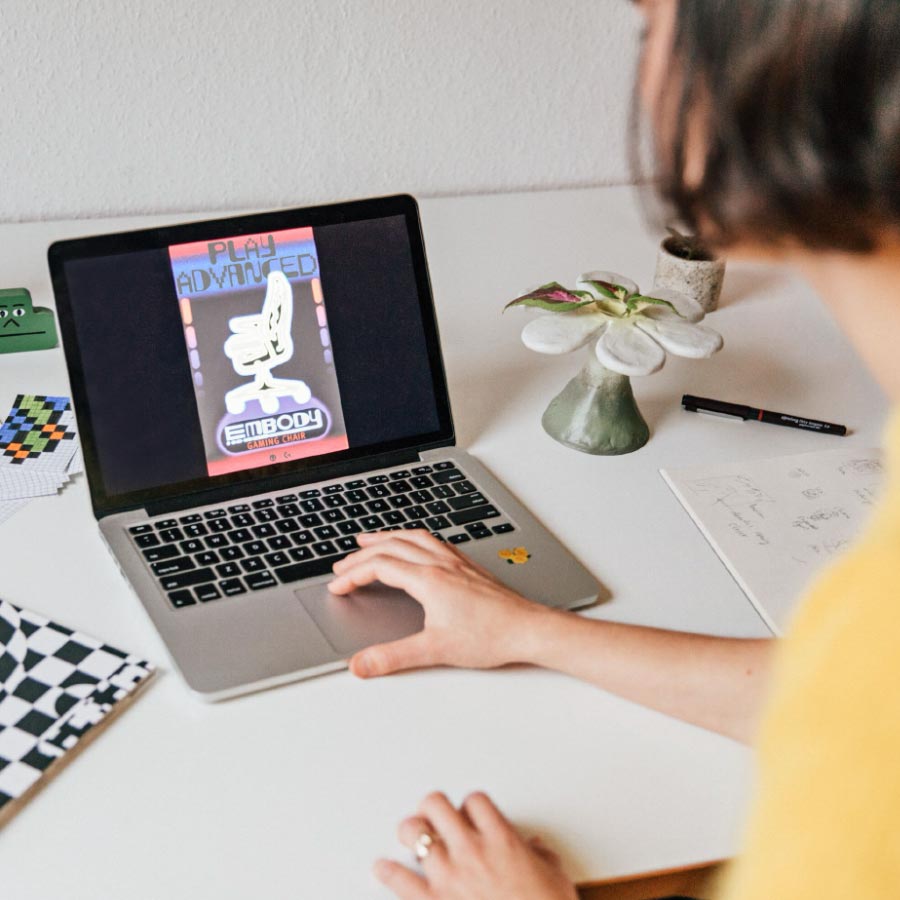 Designer Molly Rose Dyson working on Herman Miller Embody poster on a laptop