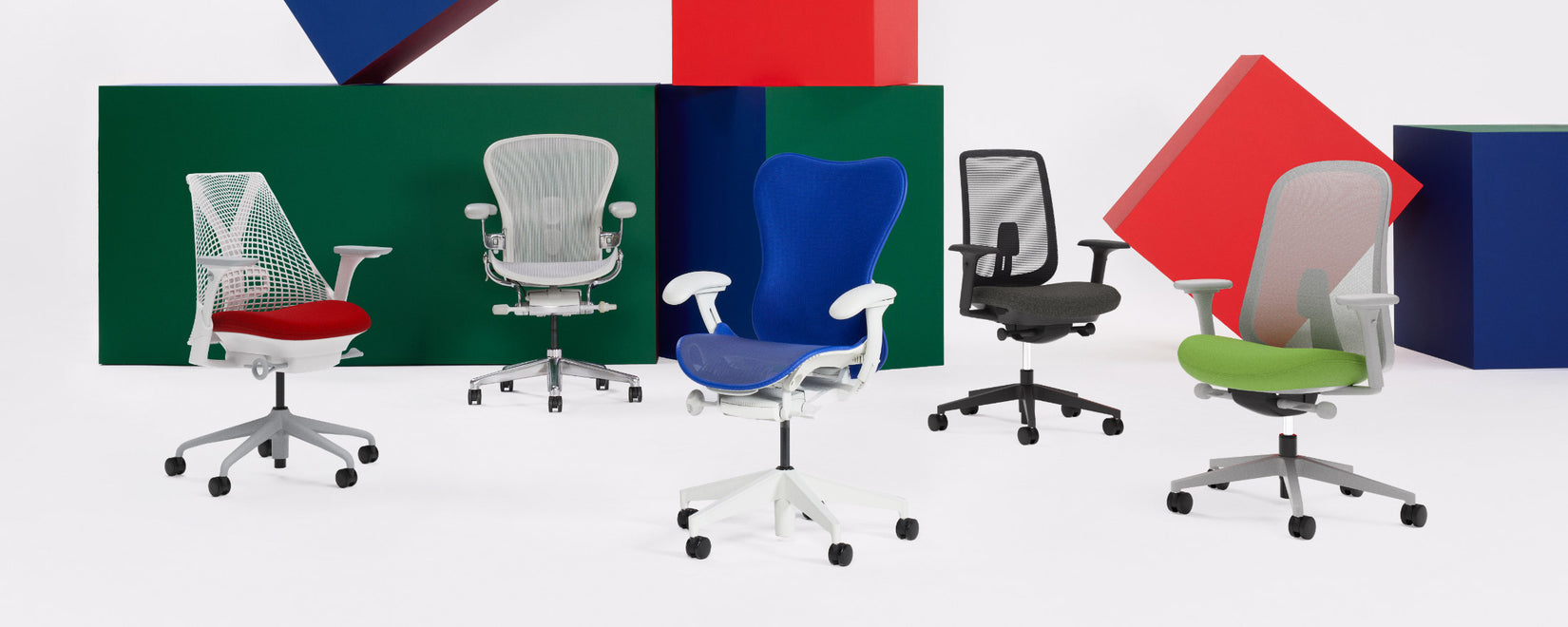 A lineup of Herman Miller office chairs in a studio environment including Sayl, Aeron, Mirra 2, Verus and Lino in a variety of colours.