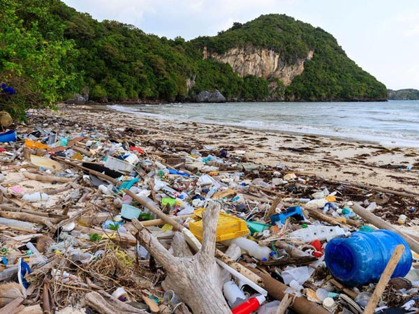 Photo of a beach covered in plastic highlighting where Herman Miller recover the plastic to use in new products