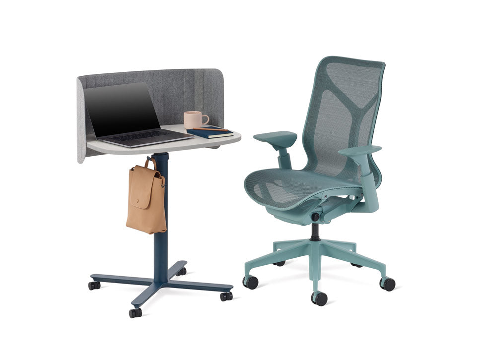 A blue Cosm office chair by Herman Miller positioned alongside a blue and white Passport table by Herman Miller.
