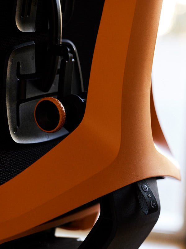 Close-up of a yellow and black Vantum gaming chair by Herman Miller, showing the tilt feature.