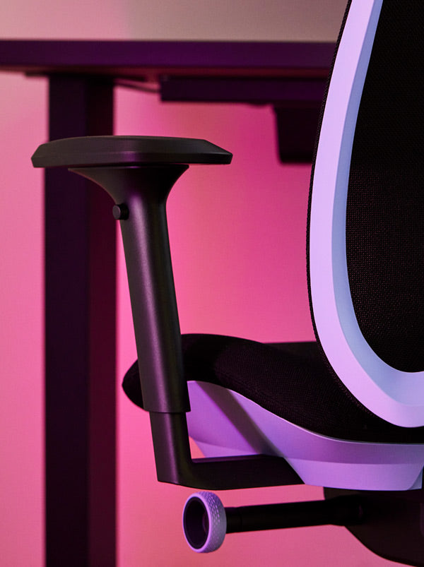 Close-up of a purple and black Vantum gaming chair by Herman Miller, showing the armrest.