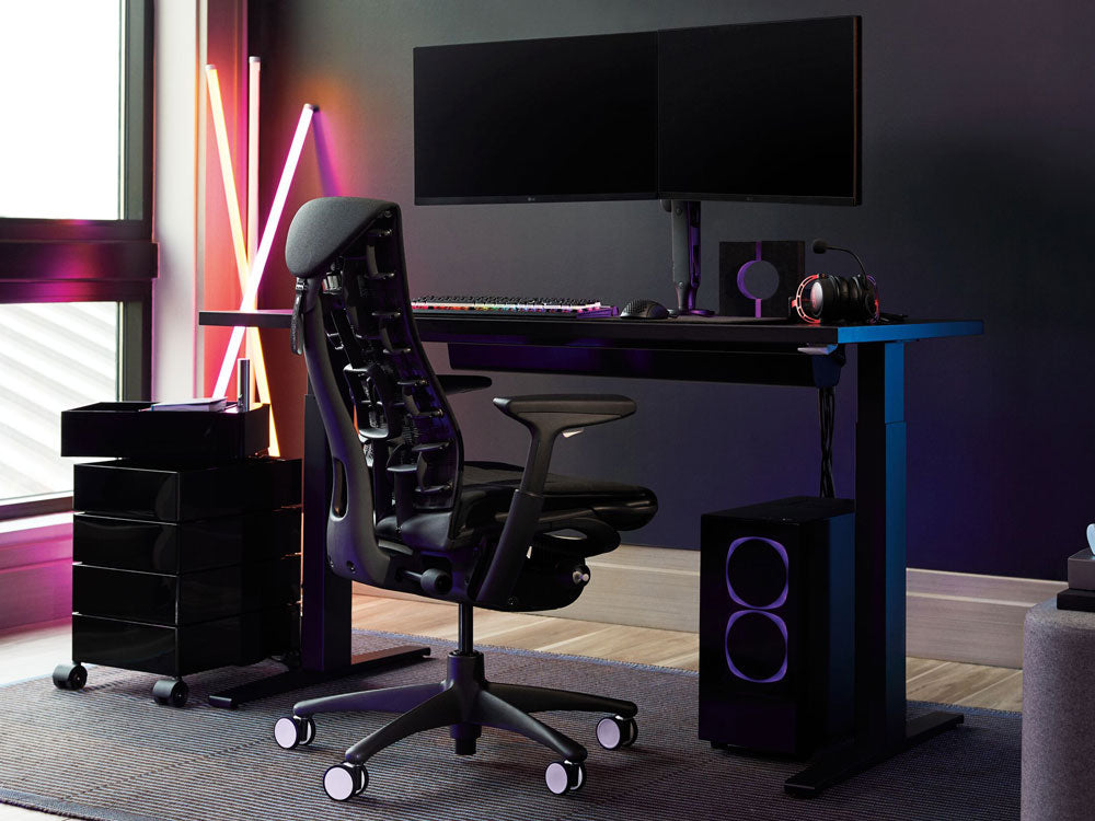 A Herman Miller Embody Gaming Chair as part of a setup featuring a Nevi sit-stand desk