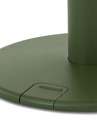 Close-up of a green OE1 standing desk by Herman Miller, showing the foot-controlled up/down pedal.