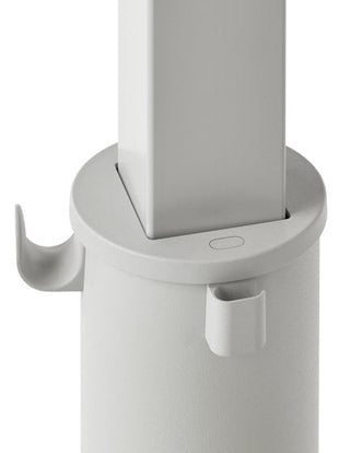 Close-up of a grey OE1 standing desk by Herman Miller, showing the bag hook and cable tidy.