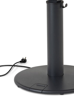 Close-up of a black OE1 standing desk by Herman Miller, showing the power cable.