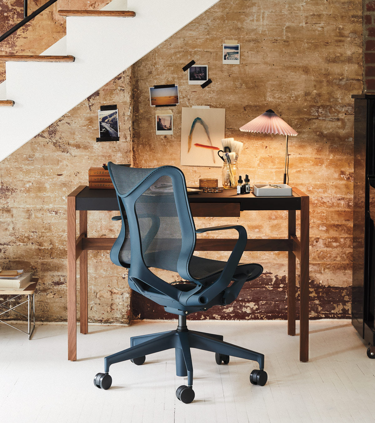 Home office space under staircase featuring Cosm low back in nightfall blue in front of wooden desk with a Hay Matin desk lamp