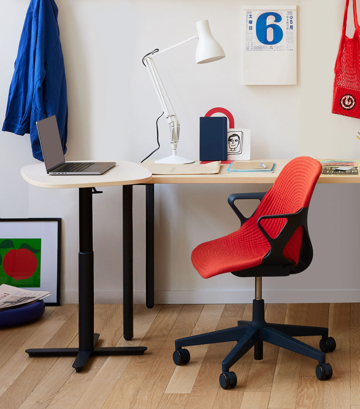 Home office space featuring Zeph office chair in carbon with blaze red cover, with OE1 desk and portable Passport work table