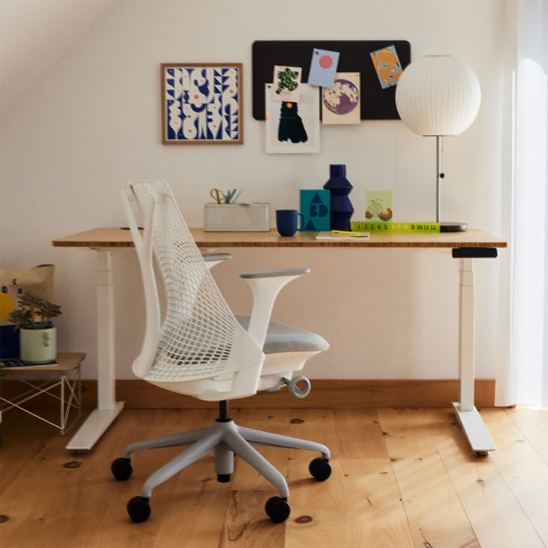 Home office featuring Sayl office chair in white and grey in front of Jarvis sit stand desk in white with bamboo top