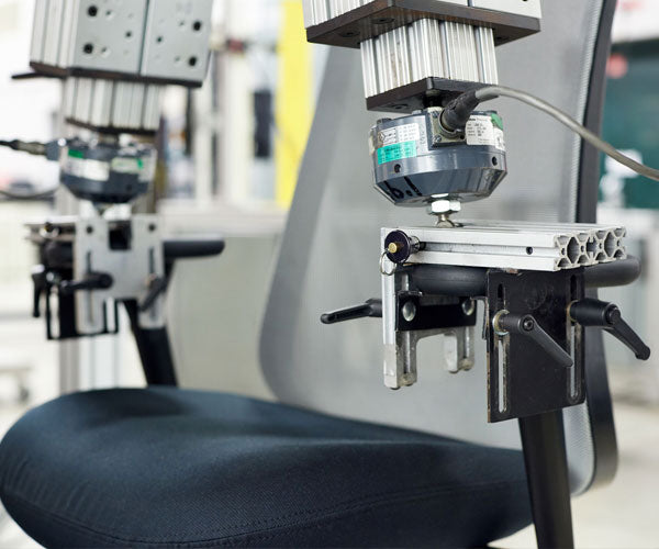 Photo of dual arm test that replciates the weight, pressure and wear that all Herman Miller chairs go through.