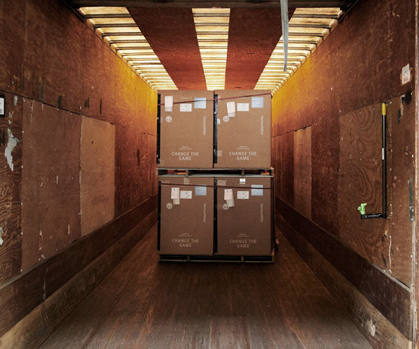 Photo of the transportation test showing boxed and packaged chairs in a shipping contain. It drops boxes replicating shipping process to ensure that all Herman Miller chairs arrive perfectly