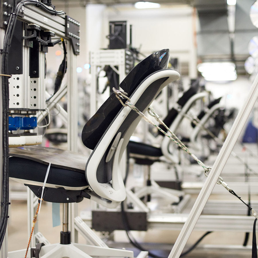 Photograph of Herman Miller chair being tested for durability in the Herman Miller test lab