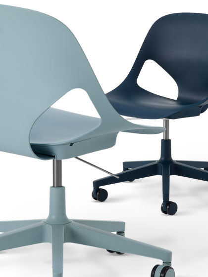 Two Herman Miller Zeph office chairs, one in light blue and one in dark blue.