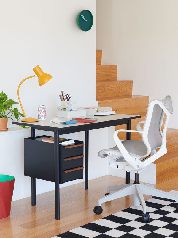 Home office with Mode fixed height desk with draw storage and white low back Cosm office chair with various office accessories.