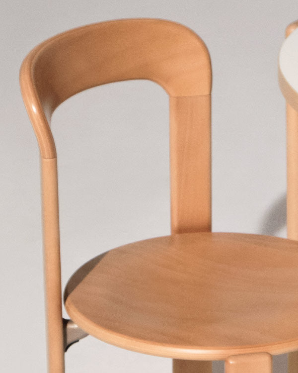 Close-up of a beech Rey chair by HAY, showing the curved edges.